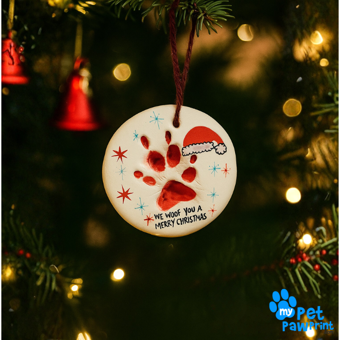 Decorative paw print Christmas ornament with paw prints and text on a Christmas tree.